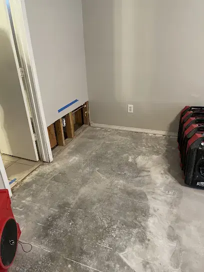 Flood cut drywall and a dehumidifier drying a Carrollton room to the S500 goal