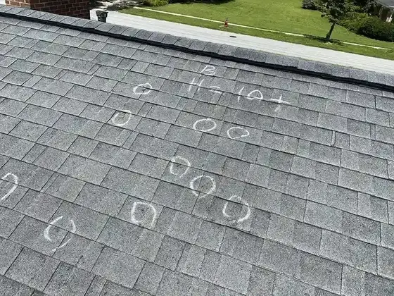 Hail hits marked on a shingle roof during a Carrollton storm damage inspection