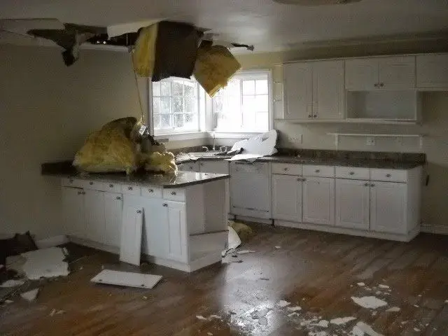 Kitchen ceiling collapsed with wet insulation after a leak above in Carrollton